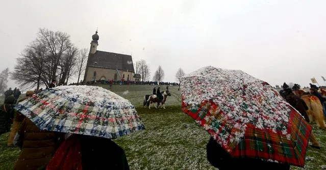 Pilgrims dressed in traditional Bavarian clothes attend the traditional Georgi horse riding procession on Easter Monday in heavy snowfall, in the southern Bavarian town of Traunstein April 6, 2015. (Photo by Michael Dalder/Reuters)