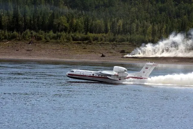 In this handout photo taken from video released by Russian Emergency Situations Ministry press service, a Russian Emergency Ministry's Beriev multipurpose amphibious aircraft Be-200 takes-off to drop water during extinguishing a forest fire in the republic of Sakha also knows as Yakutia, Russia Far East, Sunday, July 18, 2021. Russia has been plagued by widespread forest fires, blamed on unusually high temperatures and the neglect of fire safety rules, with Sakha-Yakutia in northeastern Siberia being the worst affected region lately. Local emergency officials said 187 fires raged in the region on Sunday, and the total areas engulfed by blazes have grown by 100,000 hectares (about 247,000 acres) in the past 24 hours. (Photo by Russian Emergency Situations Ministry Press Service via AP Photo)