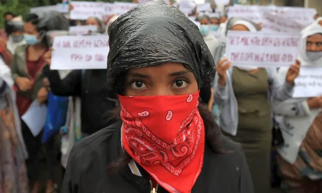 Eritrean Refugees protest in-front of the United Nations High Commissioner for Refugees (UNHCR) offices to condemn the attacks on the refugees in Hitsats and Shimelba camps during the fight between Ethiopia's National Defence Force and Tigray People Liberation Front (TPLF) in Addis Ababa, Ethiopia on July 29, 2021. (Photo by Tiksa Negeri/Reuters)