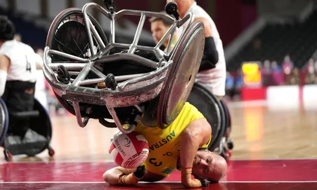Australia's Ryley Batt falls during the wheelchair rugby bronze medal match against Japan at the Tokyo 2020 Paralympic Games, Sunday, August 29, 2021, in Tokyo, Japan. Each athlete has unique differences that have to be classified according to individual impairments. (Photo by Shuji Kajiyama/AP Photo)