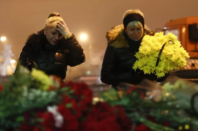 Women cry laying flowers outside the Volgograd main railway station in Volgograd, Russia, early Monday December 30, 2013. (Photo by Denis Tyrin/AP Photo)