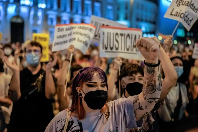 People gather at a protest at Sol square in Madrid, Spain, Wednesday, September 8, 2021, to denounce a rise in hate crimes against LGBTQ people after a high-profile case that had grabbed attention across the country took an unexpected twist. Thousands gathered in Madrid and Barcelona three days after a young man told police that he had been brutally assaulted by a group of hooded assailants in the Spanish capital. He said that his unidentified aggressors used a knife to slash his lip and carve a homophobic slur into one of his buttocks. The banner reads: “Freedom Equality, Secularism”. (Photo by Manu Fernandez/AP Photo)