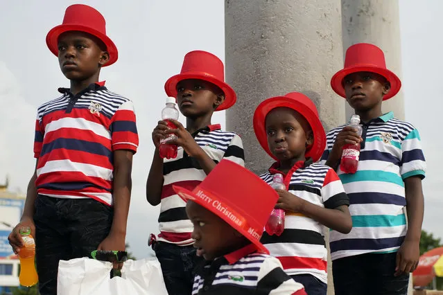 Children pose for a photograph in Kinshasa, Congo, Tuesday December 25, 2018. Traditionally Congolese dress up and take to the parks on Christmas day, this time five days before scheduled presidential and general elections. (Photo by Jerome Delay/AP Photo)