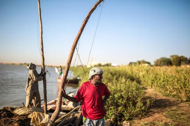 In this Wednesday, April 15, 2015 photo, Sudanese fishermen prepare their boats on the banks of the Nile River in the early morning hours, in Omdurman, Khartoum, Sudan. The world's longest river, the Nile's water is shared by 11 countries, ending in Egypt and the Mediterranean Sea. Its main tributaries, the Blue and the White Niles, meet just north of Khartoum. (Photo by Mosa'ab Elshamy/AP Photo)