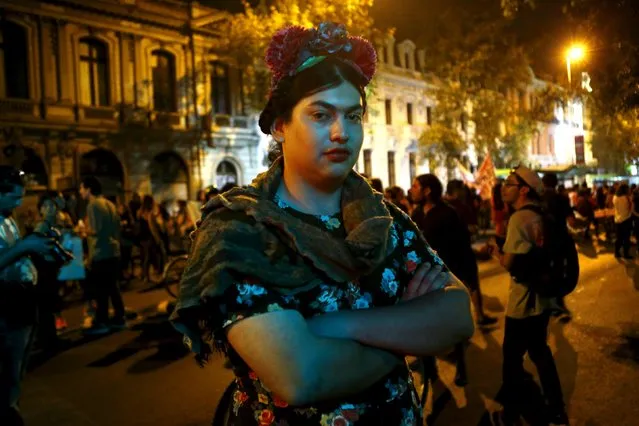 A man dressed as Mexican artist Frida Kahlo, poses for a picture during a demonstration to mark International Women's Day in Santiago, March 8, 2016. (Photo by Ivan Alvarado/Reuters)