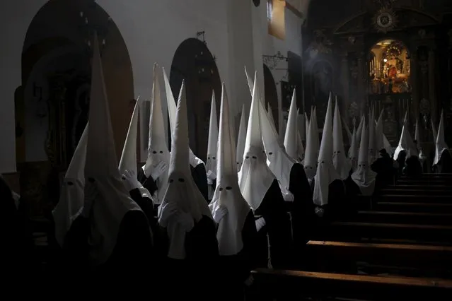 Penitents of “Dulce Nombre” brotherhood wait inside a church before they take part in a procession during Holy Week in Malaga, southern Spain, March 20, 2016. (Photo by Jon Nazca/Reuters)