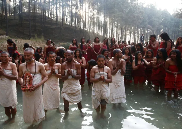 Devotees gather while performing religious rituals during the Swasthani Bratakatha festival in the woods of Changu Narayan in Bhaktapur, Nepal February 8, 2017. (Photo by Navesh Chitrakar/Reuters)