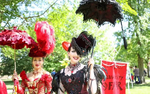 People take part in the Strawberry Fair parade in Cambridge, England on June 1, 2019. Thousands of revellers enjoy the free, independent, volunteer run festival of arts and music at the annual Strawberry Fair. (Photo by Penelope Barritt/Shutterstock)