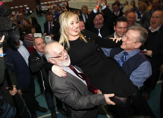 Sinn Fein's party leader for Northern Ireland Michelle O'Neill celebrates with party members Francie Molloy, left, and Ian Milne, right, after toping the poll in Mid Ulster, Ballymena count centre, Northern Ireland, Friday, March 3, 2017. Counting has begun across Northern Ireland with Irish Nationalists seeking to boost their vote in an early election that could shape the fate of the Catholic-Protestant cooperation in Northern Ireland. (Photo by Peter Morrison/AP Photo)