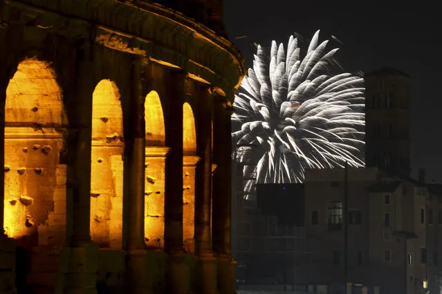 Fireworks explode in the sky next to Rome's Colosseum during New Year's celebrations, in Rome, Friday, January 1, 2021. Italy went into a modified nationwide lockdown for the Christmas and New Year period, with restrictions on personal movement and commercial activity similar to the 10 weeks of hard lockdown Italy imposed from March to May when the country became the epicenter of the outbreak in Europe. (Photo by Andrew Medichini/AP Photo)