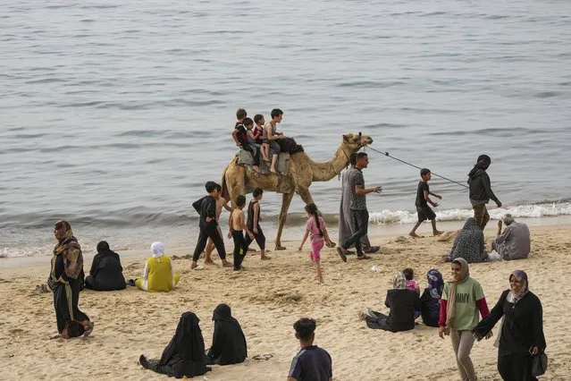 Palestinians who have been displaced by the ongoing war with Israel, spend the day on the beach along the Mediterranean Sea in Deir al Balah, Gaza Strip, April 25, 2024. (Photo by Abdel Kareem Hana/AP Photo)