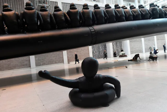 The work called “Law of the Journey” of Chinese conceptual artist and political activist Ai Weiwei, a 70- metre- long (230- foot- long) inflatable boat with 258 oversize refugee figures, is pictured at the National Gallery in Prague on March 16, 2017. Refugees are the focus of the biggest installation of Chinese dissident artist Ai Weiwei which goes on display on March 16 at the National Gallery in Prague. (Photo by Michal Cizek/AFP Photo)