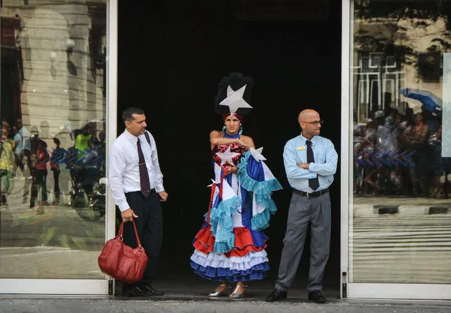 A dancer of the welcoming commission waits at the entrance of the cruise terminal in Havana as passengers of the first US-to-Cuba cruise ship to arrive in the island nation in decades get ready to disembark on May 2, 2016. The first US cruise ship bound for Cuba in half a century, the Adonia – a vessel from the Carnival cruise's Fathom line – set sail from Florida on Sunday, marking a new milestone in the rapprochement between Washington and Havana. The ship – with 700 passengers aboard – departed from Miami, the heart of the Cuban diaspora in the United States. (Photo by Jorge Beltran/AFP Photo)