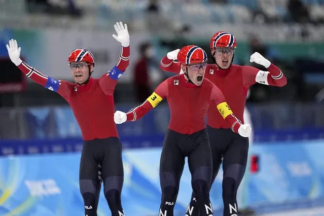 Team Norway's Peder Kongshaug, center, Sverre Lunde Pedersen, left, and Hallgeir Engebraaten react after winning the gold medal in the speedskating men's team pursuit finals at the 2022 Winter Olympics, Tuesday, February 15, 2022, in Beijing. (Photo by Sue Ogrocki/AP Photo)