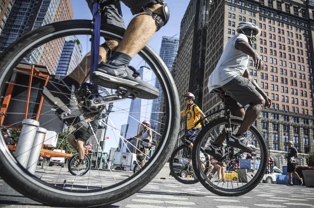 Unicyclist gather near Battery Park for a ride up the West Side to kick-off the Labor Day weekend Unicycle Festival, Thursday August 29, 2019, in New York. Festivities begin Friday afternoon with a mass ride 2pm from City Hall over the Brooklyn Bridge to Coney Island, with main events on Governors Island from 12pm-5pm on Saturday and Sunday. (Photo by Bebeto Matthews/AP Photo)