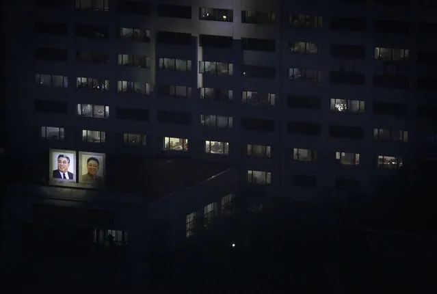 The portraits of the late North Korean leaders Kim Il Sung and Kim Jong Il are illuminated on the side of a building on Friday, May 6, 2016, in Pyongyang, North Korea. (Photo by Wong Maye-E/AP Photo)