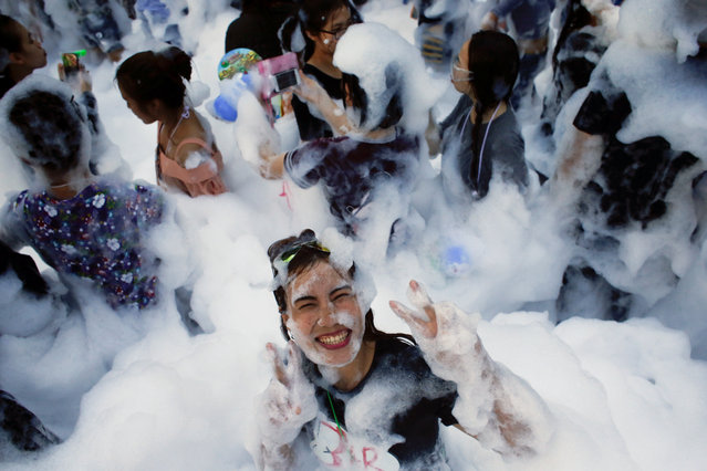 A reveller reacts at a foam party during Songkran Festival celebrations in Bangkok, Thailand on April 13, 2017. (Photo by Jorge Silva/Reuters)