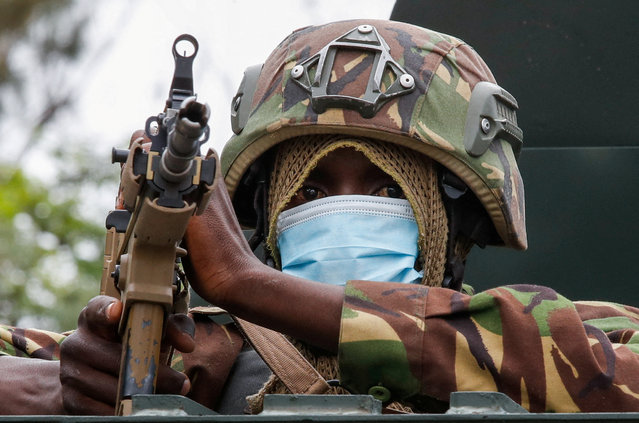 A member of the Kenya Defence Forces holds a weapon from a military vehicle as Kenya Defence Forces are deployed to curb a demonstration over police killings of people protesting against Kenya's proposed finance bill 2024/2025, in Nairobi, Kenya, on June 27, 2024. (Photo by Monicah Mwangi/Reuters)