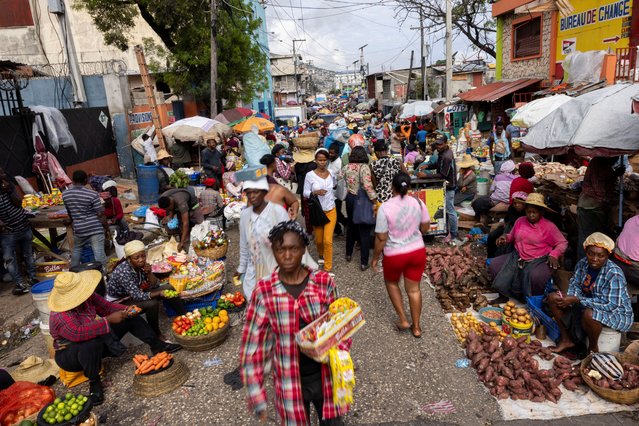 People walk through the Petionville street market in Port-au-Prince, Haiti on May 2, 2024. (Photo by Ricardo Arduengo/Reuters)