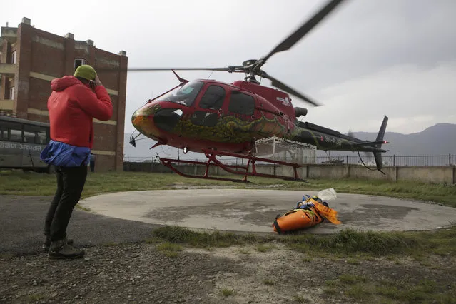 A helicopter lifts off after transporting the body of famed Swiss climber Ueli Steck at Teaching Hospital in Kathmandu, Nepal, Sunday, April 30, 2017. 40-year-old Steck, one of the most-renowned mountaineers of his generation, was killed Sunday in a mountaineering accident near Mount Everest in Nepal, expedition organizers said. He was best known for his speed-climbing, including setting several records for ascending the north face of the Eiger, a classic mountaineering peak in the Bernese Alps that he climbed in two hours and 47 minutes without using a rope. (Photo by Niranjan Shrestha/AP Photo)