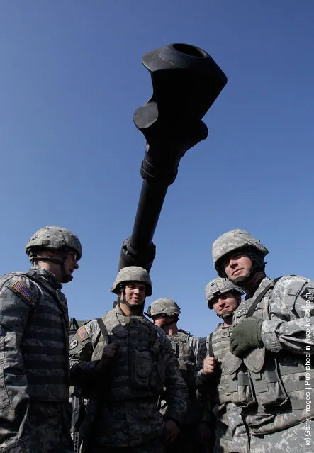 U.S. soldiers from 145th Field Artillery Battalion deployed from the United States and South Korean soldiers participate the Foal Eagle training exercise at firing point 180 at the Rodriguez Live Fire Range on March 15, 2012 in Pocheon, South Korea