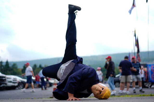 “Breakdancer for Trump” Victor Moon performs wearing a Donald Trump mask before a campaign rally for Republican presidential nominee former President Trump at the Mohegan Sun Arena at Casey Plaza, Saturday, August 17, 2024, in Wilkes-Barre, Pa. (Photo by Carolyn Kaster/AP Photo)