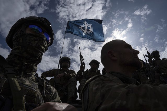 Fighters of Russian Volunteer Corps stand atop on an APC during press conference not far from the border in Sumy region, Ukraine, Wednesday, May 24, 2023. Russia's military said Tuesday it quashed what appeared to be one of the most serious cross-border attacks from Ukraine since the war began, claiming to have killed more than 70 attackers in a battle that lasted around 24 hours. (Photo by Evgeniy Maloletka/AP Photo)