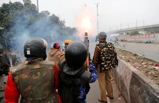 A riot police officer fires tear gas towards demonstrators during a protest against a new citizenship law in Seelampur, area of Delhi, India December 17, 2019. (Photo by Danish Siddiqui/Reuters)