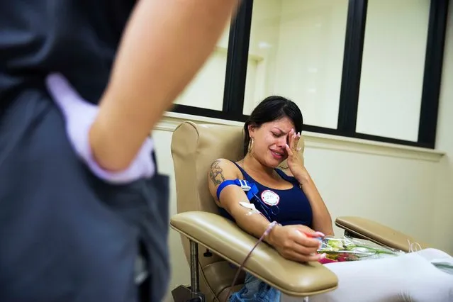 Tatiana Osorio, of Orlando, cries while giving blood at the OneBlood blood center near the mass shooting at a nightclub, June 13, 2016, in Orlando, Fla. Osorio lost three friends in the shooting. (Photo by David Goldman/AP Photo)