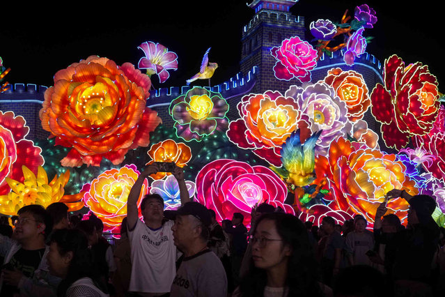 Visitors tour the grand lantern show on display at the Garden Expo Park on the eve of Mid-Autumn Festival in Beijing, Sunday, September 15, 2024. (Photo by Andy Wong/AP Photo)