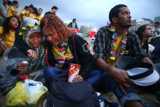 Brazil fans are devastated while watching the first half on Copacabana Beach during the 2014 FIFA World Cup semi-final match between Brazil and Germany on July 8, 2014 in Rio de Janeiro, Brazil. The winner advances to the final at the famed Maracana stadium. (Photo by Mario Tama/Getty Images)