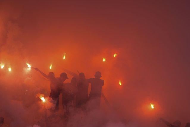 Fans of Argentina's Lanus launch fireworks before the start of a Copa Sudamericana semifinal second leg soccer match against Brazil's Cruzeiro at La Fortaleza Stadium in Buenos Aires, Argentina, Wednesday, October 30, 2024. (Photo by Natacha Pisarenko/AP Photo)