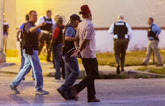 Police arrest a man as protesters gathered after a shooting incident in St. Louis, Missouri August 19, 2015. (Photo by Kenny Bahr/Reuters)