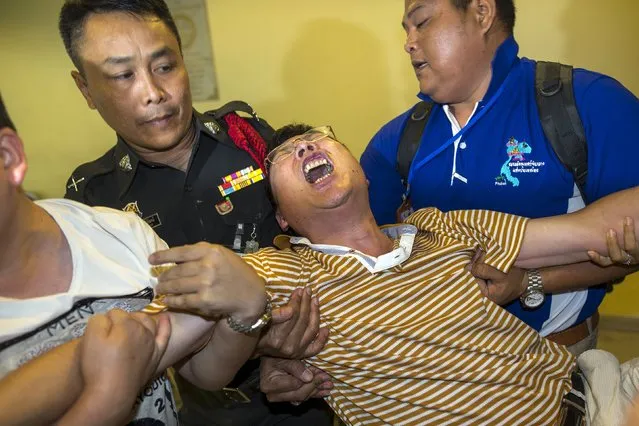 Chinese national Gao Yu Ping, who lost his wife and daughter in Monday's deadly blast, cries at the Institute of Forensic Medicine in Bangkok, Thailand, August 20, 2015. Thailand's ruling junta on Thursday said a deadly bomb attack at a religious shrine in Bangkok was “unlikely” to be the work of international terrorists, adding that the attack was not specifically targeted at Chinese tourists. (Photo by Athit Perawongmetha/Reuters)