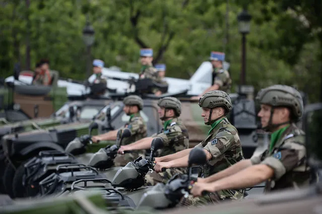 Officers of the 'commandement du renseignement' prepare for the annual Bastille Day military parade on the Champs Elysees avenue in Paris on July 14, 2016. (Photo by Stephane De Sakutin/AFP Photo)
