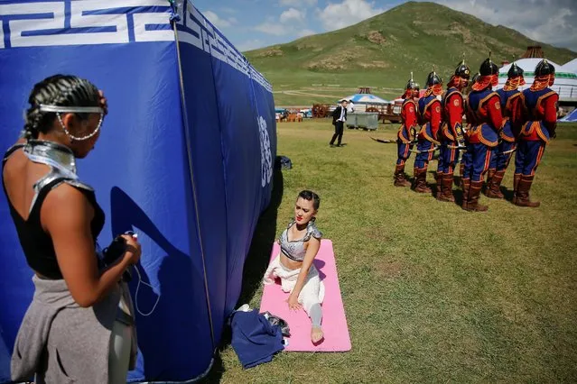 Performers warm-up as they wait for delegations to arrive for traditional nomadic Naadam festival performance during the Asia-Europe Meeting (ASEM) summit just outside Ulaanbaatar, Mongolia, July 15, 2016. (Photo by Damir Sagolj/Reuters)