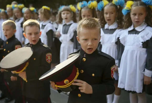 First graders of a cadet's lyceum attend a ceremony to mark the start of the new school year in Kiev, Ukraine, September 1, 2015. (Photo by Valentyn Ogirenko/Reuters)