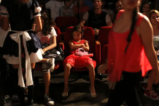 A child watches performances during the Cuban Otaku festival at a cinema in Havana, Cuba, July 24, 2016. (Photo by Alexandre Meneghini/Reuters)