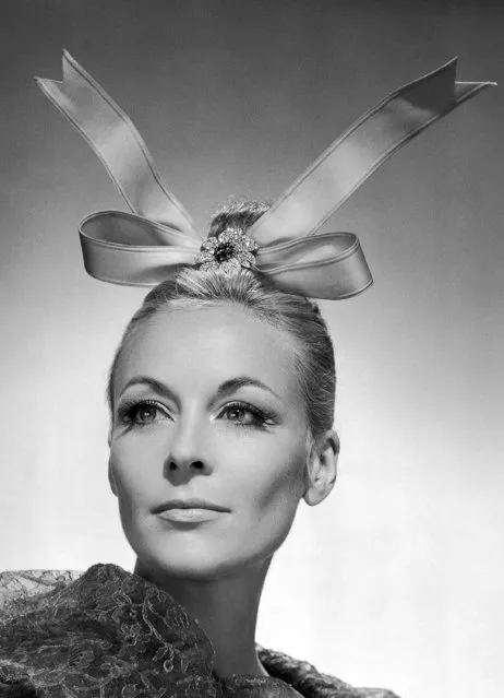 Famed French fashion designer Balenciaga created this eye catching head dress by placing a pink satin bow, ends up, on top of his models head and attaching it to a small chignon with a diamond – paved aster shown September 3, 1965. The diamond flower clip is by Van Cleef and Arpels. (Photo by AP Photo)