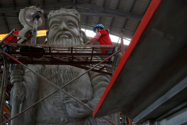 Employees paint a statue at the Chuanso factory that manufactures religious objects in Pingtung, Taiwan July 5, 2016. (Photo by Tyrone Siu/Reuters)