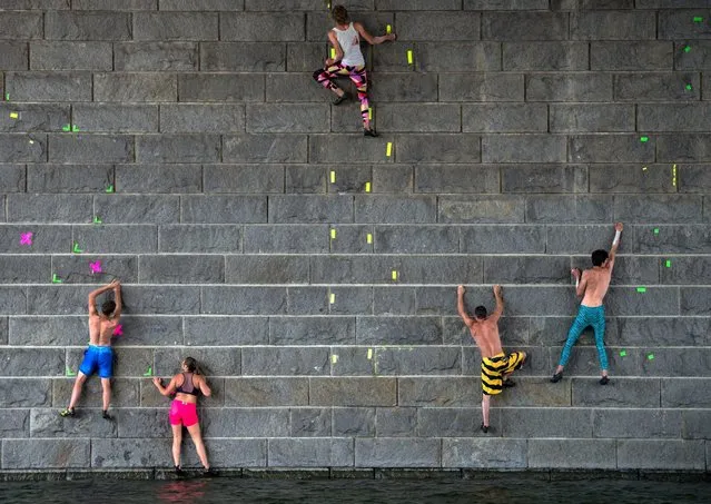 Participants climb up a prier of the Reichsbruecke over the Danube River during the “Urban Waters Cup 2016” boulder competition in Vienna, Austria, 06 August 2016. (Photo by Christian Bruna/EPA)