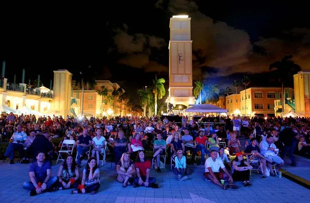 People watch the debate on a large screen at Mizner Park in Boca Raton. (Photo by Allen Eyestone/The Palm Beach Post)