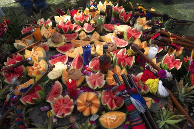 Fruit and candles are part of an altar for an Indigenous ceremony in honor of Guatemala's new President Bernardo Arévalo at the sacred Mayan site of Kaminaljuyu in Guatemala City, Tuesday, January 16, 2024. Arévalo was inaugurated as Guatemala's new president on Monday. (Photo by Moises Castillo/AP Photo)
