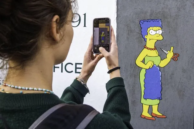 The Cut 2, the sequel, a mural created by the street artist AleXsandro Palombo shows Marge Simpson, a character in the animated sitcom “The Simpsons”, shows her “middle finger” in solidarity with Mahsa Amini and in protest against the Iranian regime, in Milan, Italy, 11 October 2022. The mural was displayed in front of the Iranian consulate in Milan. Amini, a 22-year-old Iranian woman, was arrested in Tehran on 13 September 2022 by the morality police, a unit responsible for enforcing Iran's strict dress code for women. She fell into a coma while in police custody and was declared dead on 16 September 2022. (Photo by Andrea Fasani/EPA/EFE)