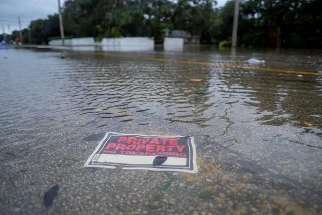 A sign lies underwater following the passage of Hurricane Nicole in Vero Beach, Florida, U.S. November 10, 2022. (Photo by Ricardo Arduengo/Reuters)