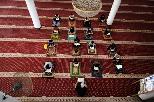 Boys keeping a safe distance from each other,attend a Koran memorization class as Palestinians ease the coronavirus disease (COVID-19) restrictions, in a mosque in Gaza City June 29, 2020. (Photo by Majdi Fathi/NurPhoto via Getty Images)