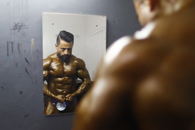 A Nepalese bodybuilder looks on a mirror while flexing backstage during the qualifying round of the 17th Dharmashree Nationwide Bodybuilding Championship, held in Kathmandu, Nepal, on Friday, March 21, 2025, where hundreds of athletes from across the country took part. The event also featured the first Women's Bodybuilding Open Championship and the 50+ Open Masters Bodybuilding Championship. (Photo by Skanda Gautam/ZUMA Press Wire/Rex Features/Shutterstock)