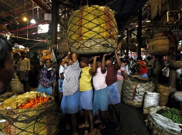 Workers carry a packed basket of vegetables at a wholesale vegetable market in Kolkata, in this February 27, 2015 file photo. (Photo by Rupak De Chowdhuri/Reuters)