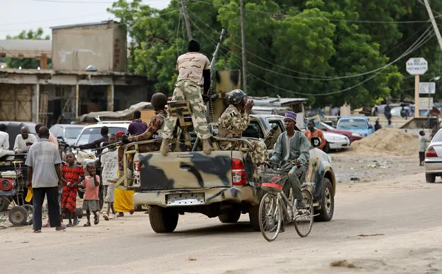 A man cycles past a military truck in Maiduguri, Borno State, Nigeria, August 31, 2016. (Photo by Afolabi Sotunde/Reuters)