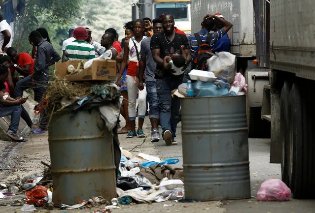 African migrants stranded in Costa Rica walk near garbage on the Inter-American highway at the border between Costa Rica and Nicaragua, in Penas Blancas, Costa Rica, September 8, 2016. (Photo by Juan Carlos Ulate/Reuters)